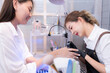 © Wosunan - A nail technician is painting the nails of a customer.