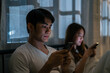 © Kawee - Asian young phone addict couple don't pay attention with each other.