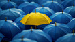 © Ikhou - A yellow umbrella stands out from the crowd of blue umbrellas, symbolizing unique individuality and self-expression