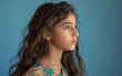© JO BLA CO - A young girl of Middle Eastern descent with long brown hair and blue eyes looking at the camera