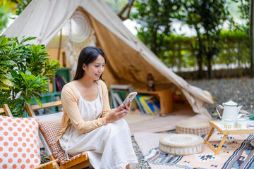 Sticker - Woman use mobile phone in the camp site