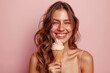 © mariof - Happy young woman with sweet ice-cream in waffle cone on pastel color background