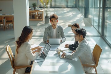 Poster - Top view angle of modern minimalist a group asian staff wears a causal modern cloth with modern hairstyle, is happily brainstorm in modern office with laptop and document on a table. Generative AI.