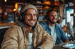 © Art_You - Two happy men in their thirties recording a podcast in a cozy studio