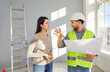 © Studio Romantic - Meeting of pretty female homeowner and attractive, smiling foreman for apartment renovation. Discussion of details on changing layout and design of living space. Engineering and construction works.
