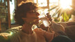 © nialyz - Serene Moment at Home - Happy person drinking water in a cozy living room with sunlight streaming through the window
