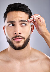 Poster - Face, salon and man with tweezers in studio isolated by white background for wellness. Thinking, hair removal and male model with facial product, eyebrows and pluck for grooming, beauty and barber