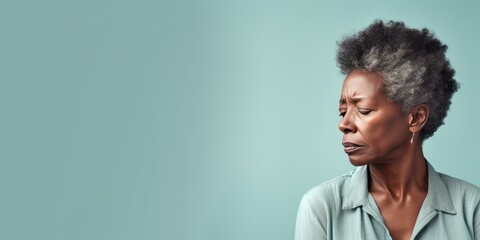 Wall Mural - Mint background sad black american independant powerful Woman realistic person portrait of older mid aged person beautiful bad mood expression Isolated on Background racism skin color depression anxie