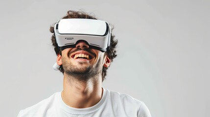Fototapete - A man in a white t-shirt smiles while wearing virtual reality glasses in front of a plain white background. Generative AI