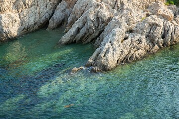 Wall Mural - the blue water and some small rocks on a beach china dalian