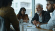 © VK Studio - Diverse business meeting in progress with a senior leader addressing the team in a boardroom.