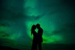 © ChaoticMind - A romantic silhouette of a couple kissing under the aurora borealis in a night sky