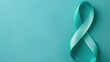 © Artyom - Teal ribbon on textured teal background, symbolizing awareness for specific causes