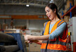 © offsuperphoto - factory worker smiling and counting money from envelope in the warehouse storage