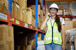 © offsuperphoto - factory worker talking on smartphone to customer in warehouse factory