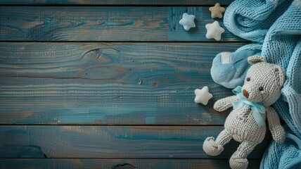 Stuffed toy rabbit with baby blanket and small stars on blue wooden background