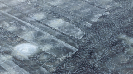 Wall Mural - Top-down view to the textures and patterns of the cracked sea-ice formations