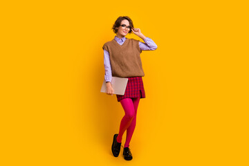 Wall Mural - Photo portrait of attractive young woman hold netbook touch specs dressed retro office clothes isolated on yellow color background