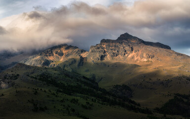 Wall Mural - the sunset is shining on the mountain tops and hills and trees