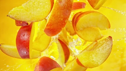 Aufkleber - Super Slow Motion of Falling Peaches Slices into Water, Colored Background. Filmed on High Speed Cinema Camera, 1000 fps. Camera Tracking the Target.