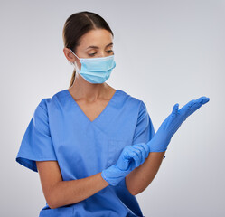 Wall Mural - Mask, nurse and woman with gloves, studio and safety with wellness and PPE for healthcare. White background, medical and person with help, professional and healthy in clinic and hands in hospital