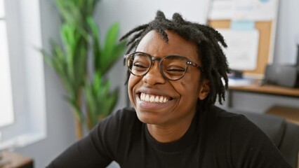 Canvas Print - Blow a lovely kiss to the camera, young, sexy, black woman with dreadlocks working on the laptop at the office.