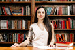 © Vladislav - Lawyer businesswoman in the courtroom at her workplace against the backdrop of a modern library. Concept of legal law, corruption and laws.