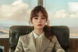 © yaqui_villegas - A professionally dressed woman sits with a contemplative expression against a backdrop with expansive views, suggesting business and travel