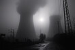 © yaqui_villegas - The sun faintly glimmers through the dense fog, silhouetting two towering power plant cooling towers