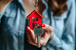 © nahid_hasan_masud - Close up female hand of real estate agent or property realtor showing a house key Mortgage, investment, rent, real estate, property concept Selective focus