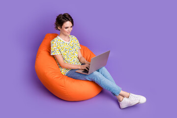 Wall Mural - Full size photo of pretty young woman use laptop wear t-shirt isolated on violet color background