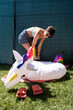 © Alvaro Lavin/Stocksy - Woman inflating an unicorn pool float.