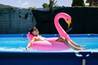 © Alvaro Lavin/Stocksy - Woman relaxing on an inflatable in a pool.