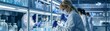 © Rattanathip - Scientists in a modern laboratory conducting experiments with lab equipment, wearing protective gear and focused on their research.