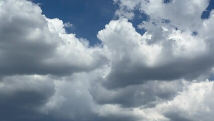 Poster - Fluffy clouds in the sky.