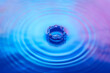 © Yaroslav Danylchenko/Stocksy - Water splash with iridescent gradient in blue and pink tones