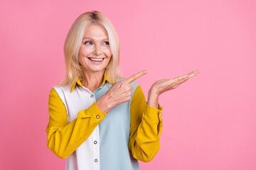 Wall Mural - Photo of elegant aged lady direct finger hold empty space wear shirt isolated on pink color background