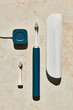 © Anna Tabakova/Stocksy - Blue electric toothbrush with accessories