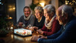 © AS Photo Family - A group of seniors shares a joyful moment as they look at a digital photo album together at night