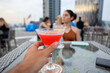 © Pedro Merino/Stocksy - POV enjoying a cocktail on the rooftop of a skyscraper