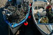 © Liam Grant/Stocksy - Lobster pots in small fishing vessels