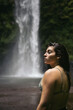 © Pedro Merino/Stocksy - Woman enjoying at a waterfall in the jungle