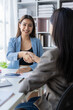 © ArLawKa - Two Asian businesswomen shake hands and congratulate each other on business success in joint financial business and investment in the company.