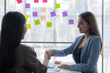 © ArLawKa - Two Asian businesswomen shake hands and congratulate each other on business success in joint financial business and investment in the company.