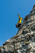 © Christine La/Stocksy - Rock climber reaching up with rope