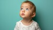 © Fokasu Art - Inquisitive infant gazes upward against a serene pastel green backdrop