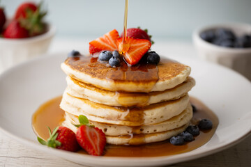 Sticker - pouring syrup on piled pancake with strawberries and bluberries