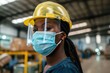 © Olena - Mask Safety: African American Women Worker Ensuring Workplace Safety with Face Shield for Health Protection at Work