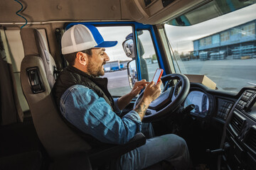 Wall Mural - Young handsome man working in towing service and driving his truck.