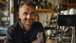 © Alina Tymofieieva - Portrait of a young barista in a cafe behind the bar counter. Happy man working in a cafe. Coffee making concept, small business.